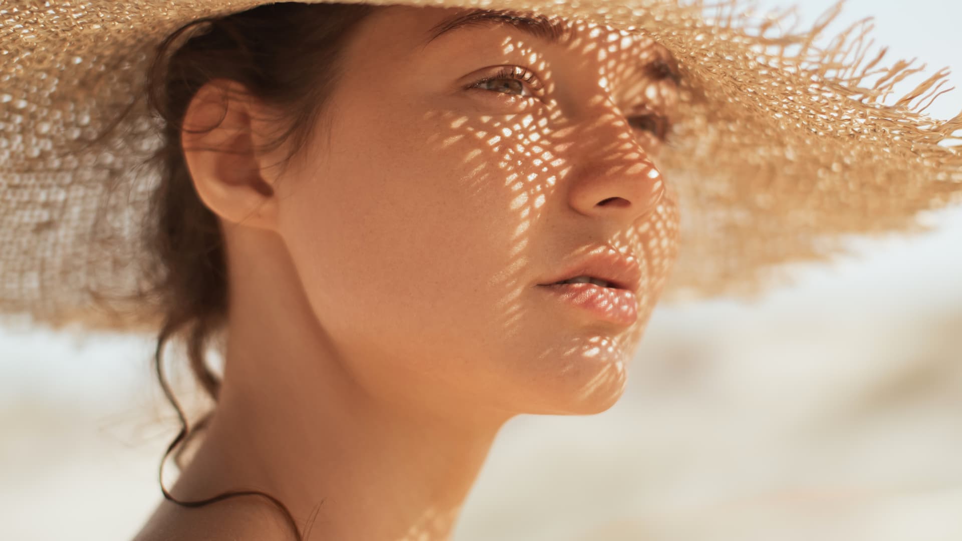 Frau mit Sonnencreme unter Make-up