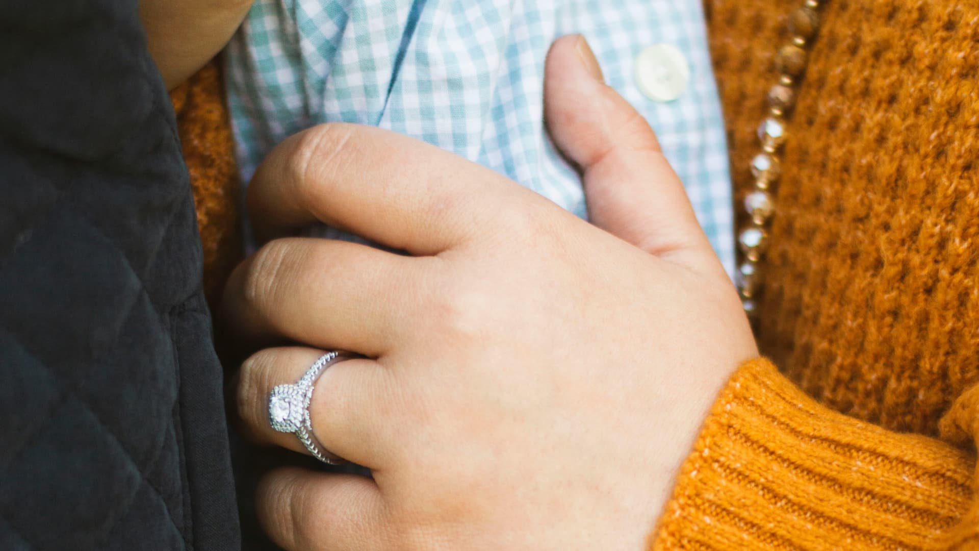 Eine Frau mit passendem Verlobungsring am Finger