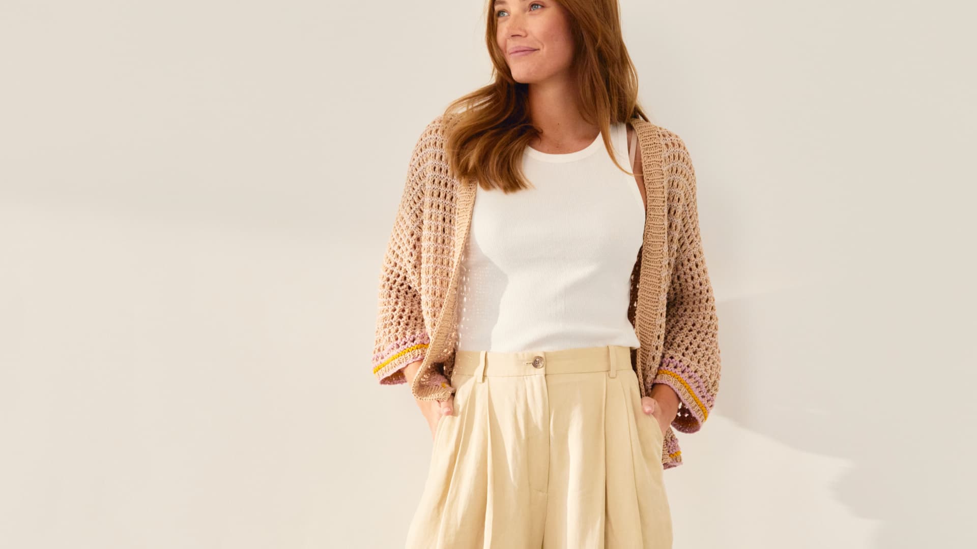 Model in Lochmuster-Strickjacke von Lana Grossa