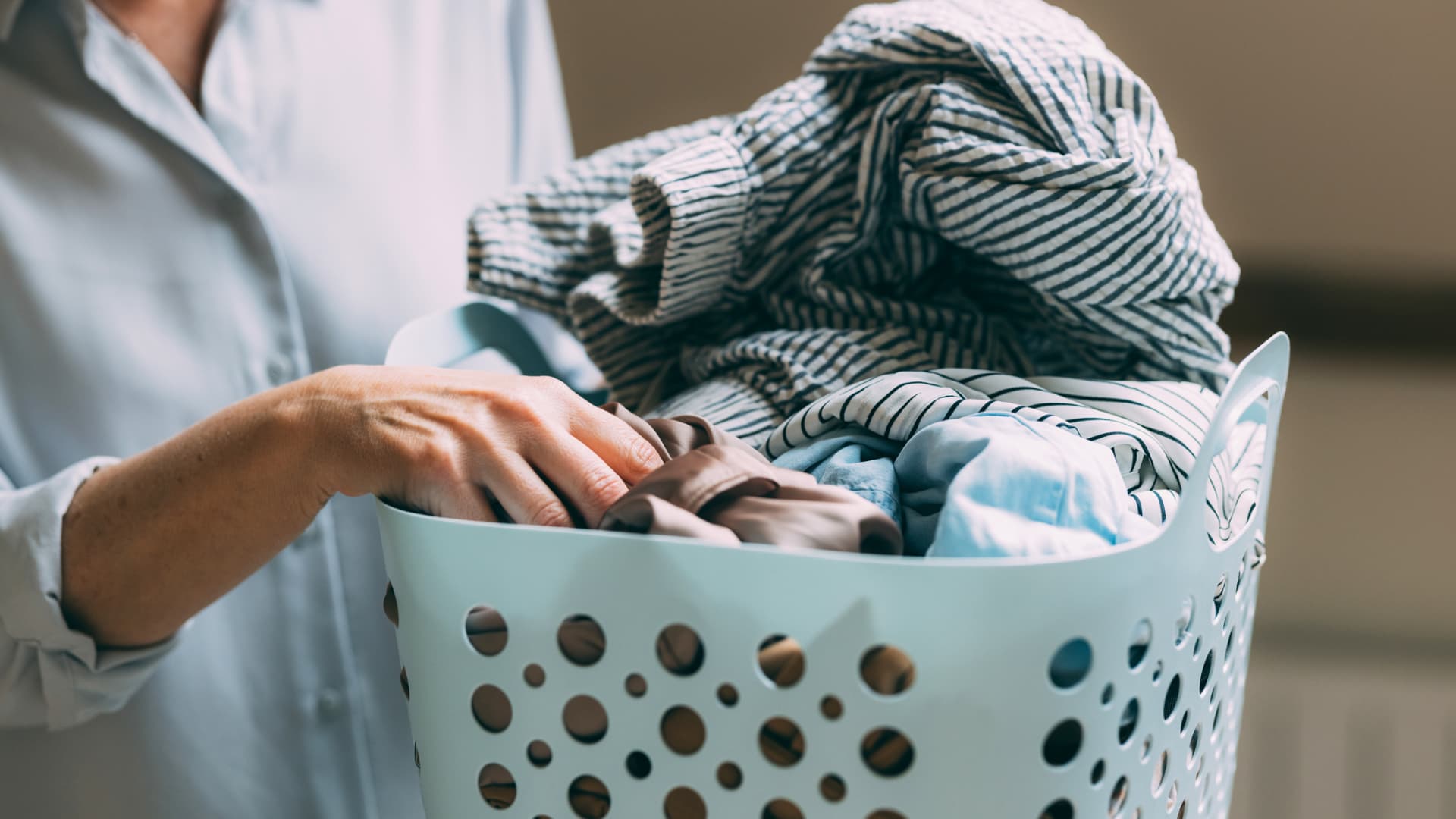 Frau dreht Wäsche vor dem Waschen auf links