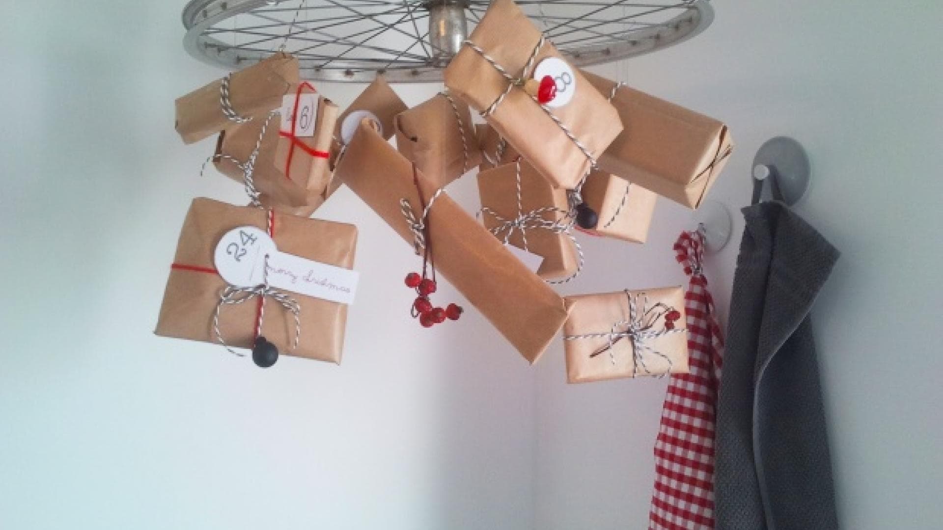 Selbstgemachter Adventskalender mit Geschenken an einem Rad