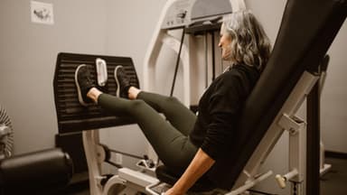 Eine Frau auf der Beinpresse macht Krafttraining ab 60 Jahren.