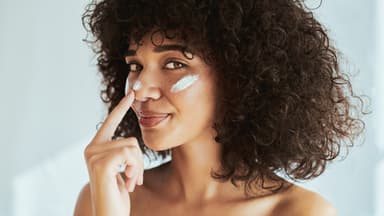 Frau trägt die beste Sonnencreme fürs Gesicht von dm auf