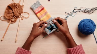 Frau strickt mit einem Nadelspiel