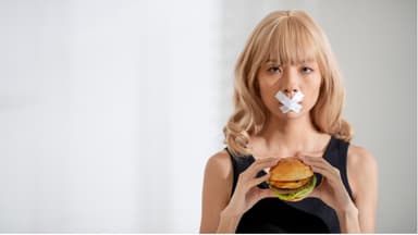 Eine Frau hält einen Burger in der Hand