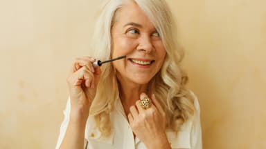 Frau verwendet Anti-Aging-Mascara mit Hyaluron