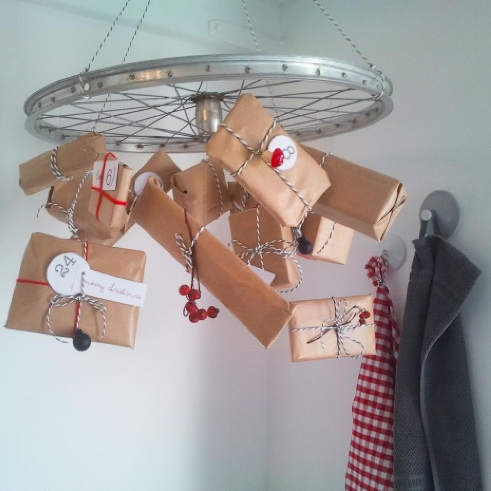 Selbstgemachter Adventskalender mit Geschenken an einem Rad