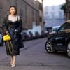 Frau trägt Lederkleid im eleganten Streetstyle.