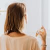 Frau sprüht Parfum wie frische Wäsche