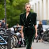 Frau trägt ein grünes Samtkleid im eleganten Streetstyle.