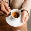 Eine Tasse Espresso in der Hand