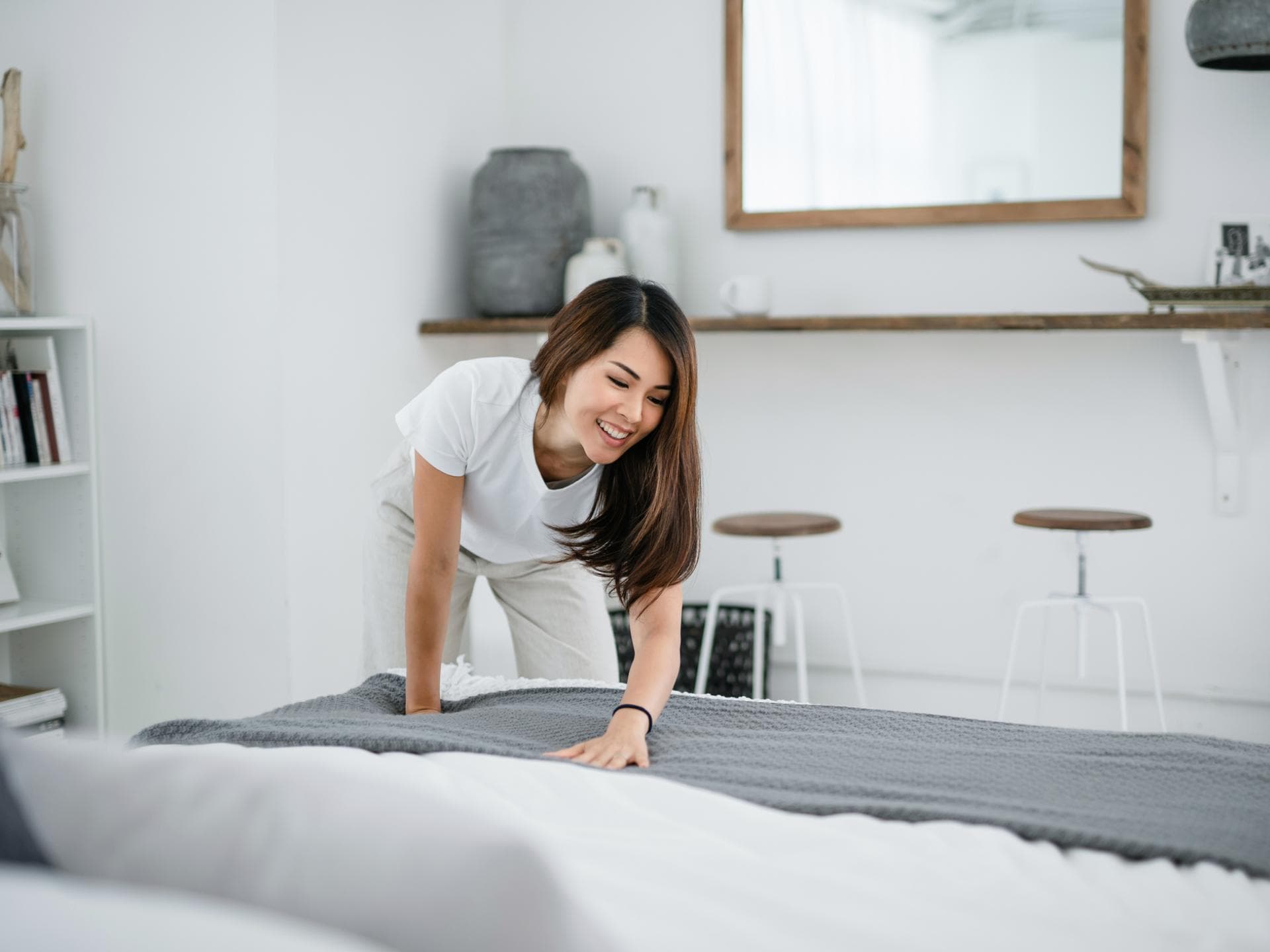 Frau macht das Bett