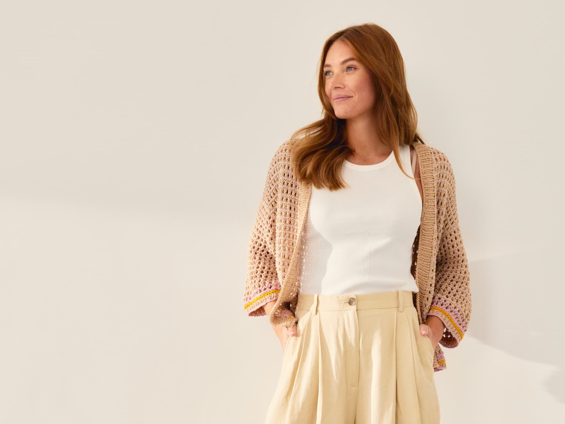 Model in Lochmuster-Strickjacke von Lana Grossa