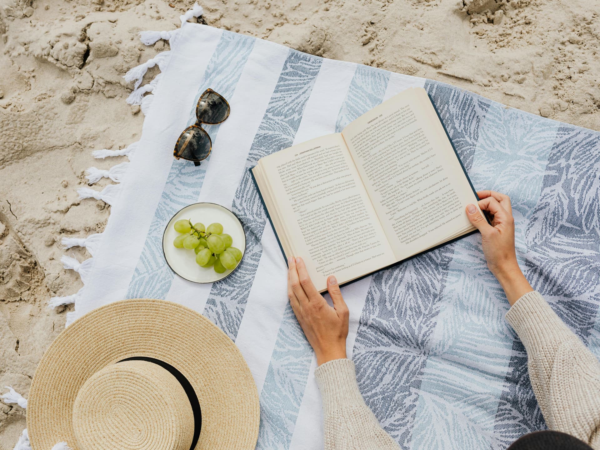Wir stellen Ihnen die besten Bücher für den Urlaub vor Frau liest ein Buch im Urlaub