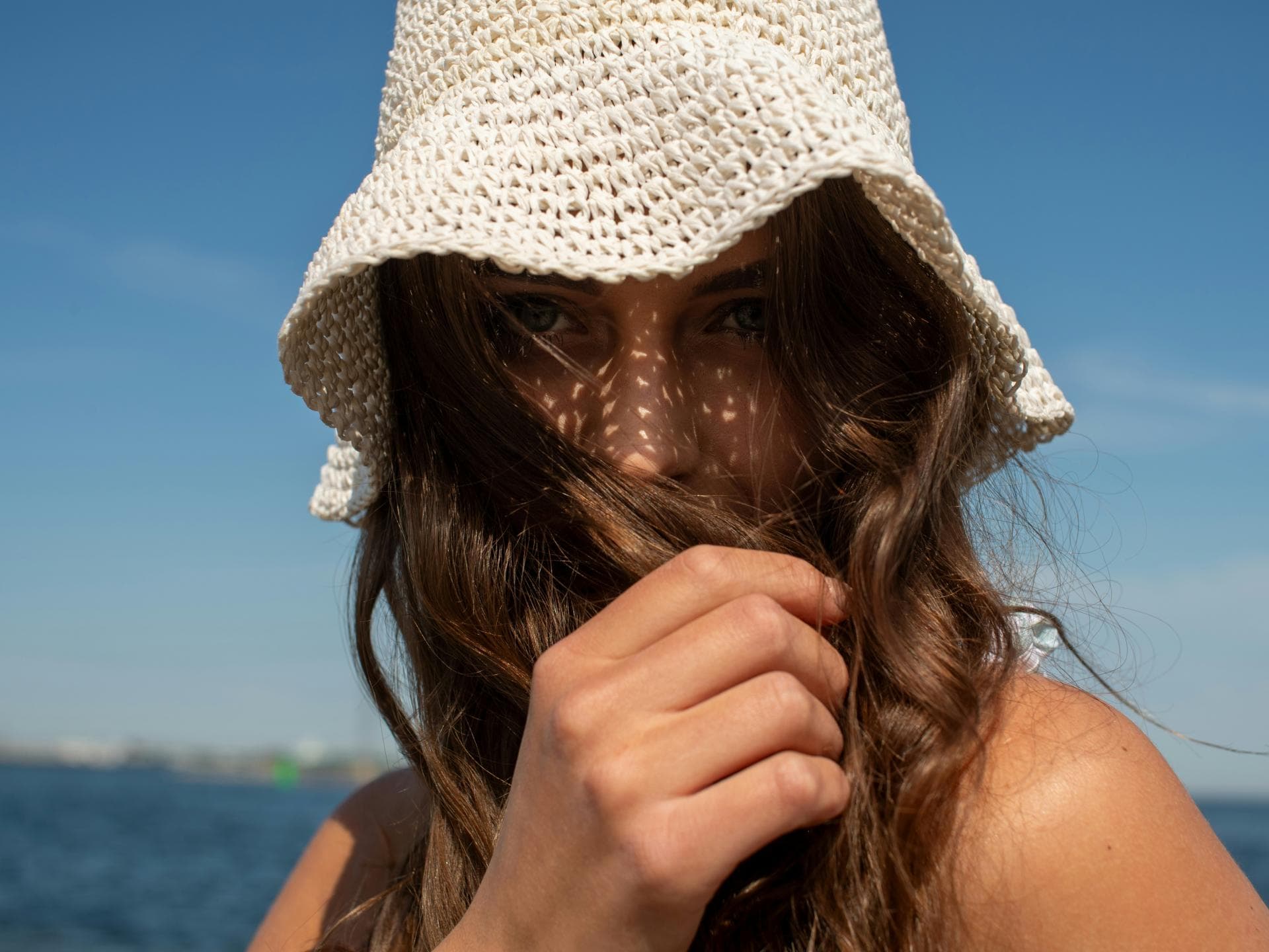 Frau mit bester Sonnencreme für empfindliche Haut im Gesicht