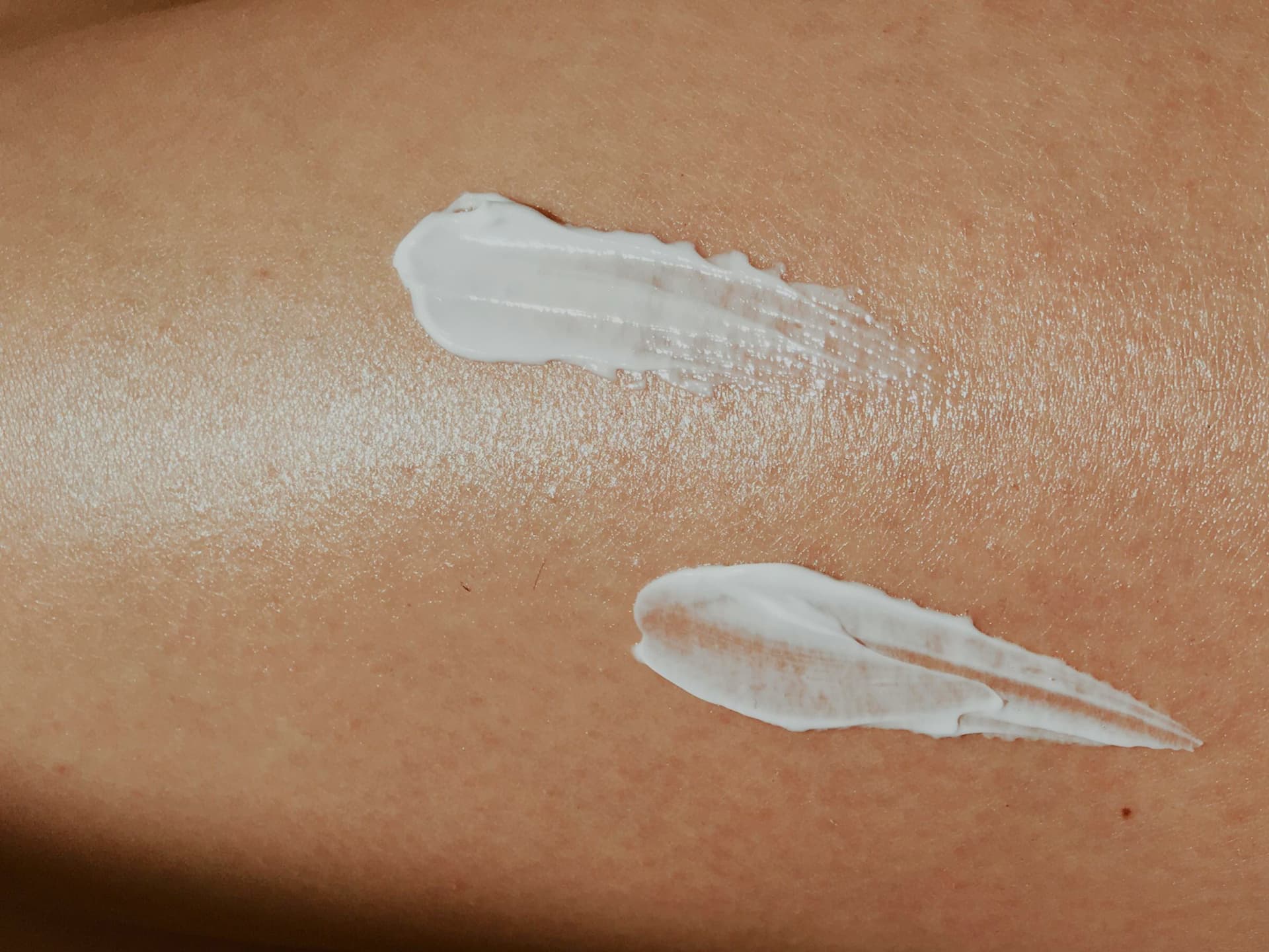 Frau mit Sonnencreme für reifer Haut auf dem Körper