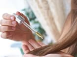 Beauty-Chefin Isabell Stiller trägt Apfelessig mithilfe einer Pipette auf dem Haar auf