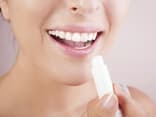 Frau trägt Lippenbalsam auf